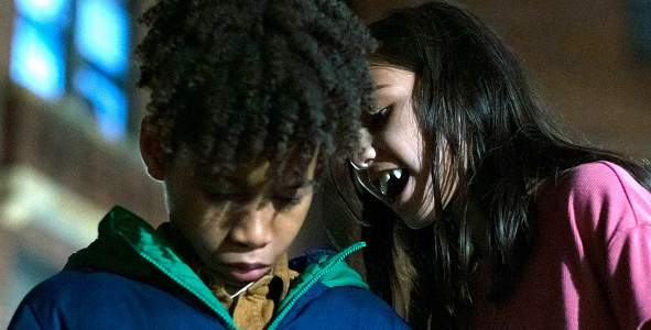 Eleanor (Madison Taylor Baez ) about to bite Isiaiah's (Ian Foreman) neck on "Let The Right One In" on Showtime