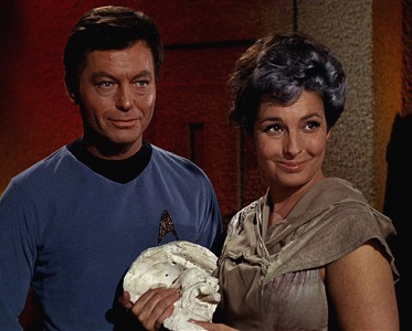 American actor DeForest Kelley (1920 - 1999) as Dr. Leonard 'Bones' McCoy and American actress Jeanne Bal (1928 - 1996) as Nancy Crater appear in a scene from 'The Man Trap,' the premiere episode of 'Star Trek,' which aired on September 8, 1966. (Photo by CBS Photo Archive )